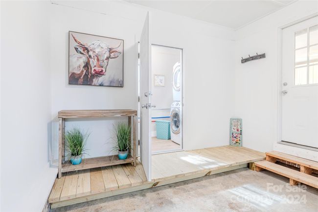 View into laundry room off garage! A platform allows you to use this for extra pantry space or storage! | Image 34