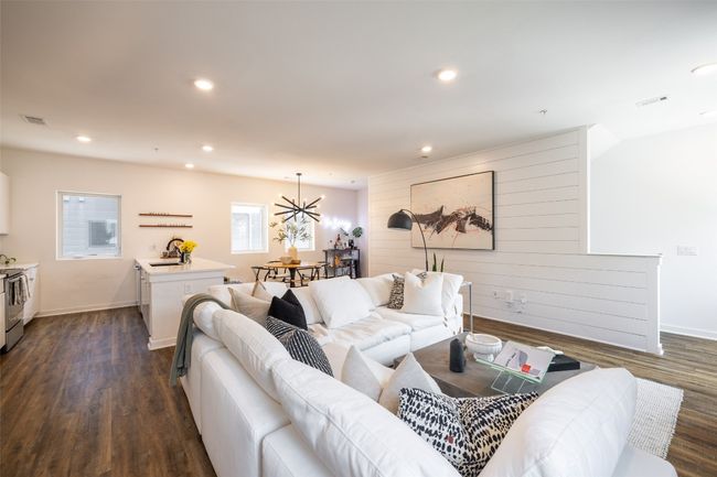 Living room with dark wood-style flooring, baseboards, a chandelier, recessed lighting, and visible vents | Image 11