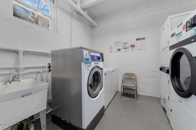 Common laundry area featuring separate washer and dryer, a sink, and concrete block wall | Image 26