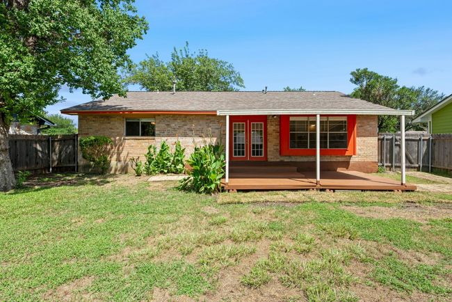 Back of property featuring a fenced backyard, a wooden deck, brick siding, and roof with shingles | Image 23