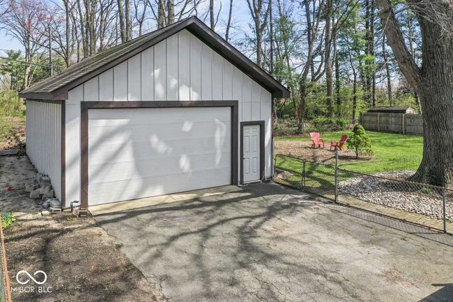 detached garage featuring fence | Image 34