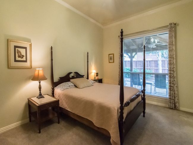 Large primary bedroom with crown molding, ceiling fan, and crown molding. | Image 19