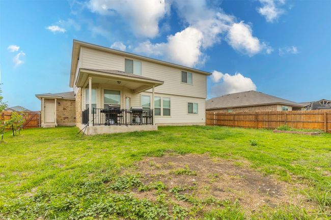 Rear view of property with a lawn, a patio, and a fenced backyard | Image 36