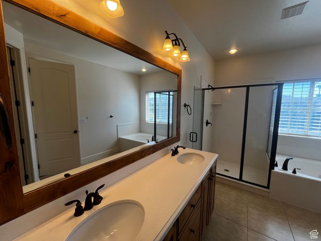Bathroom featuring a bath, healthy amount of natural light, a shower stall, and recessed lighting | Image 15