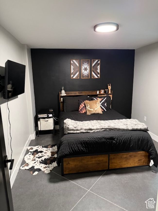 Bedroom featuring finished concrete flooring and baseboards | Image 21