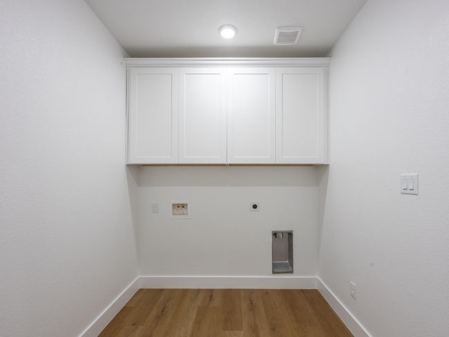 Upper cabinetry provides plenty of space to store cleaning supplies and linens. Durable luxury vinyl flooring continues the clean, modern aesthetic. | Image 29