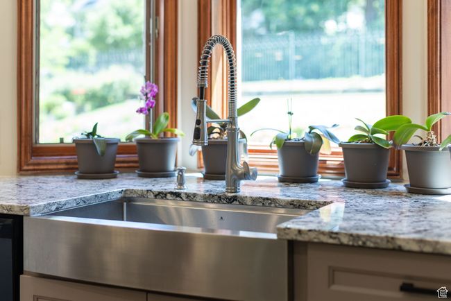 Kitchen view of light stone countertops | Image 7