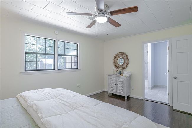 Bedroom with ceiling fan, dark hardwood / wood-style flooring, and crown molding | Image 34