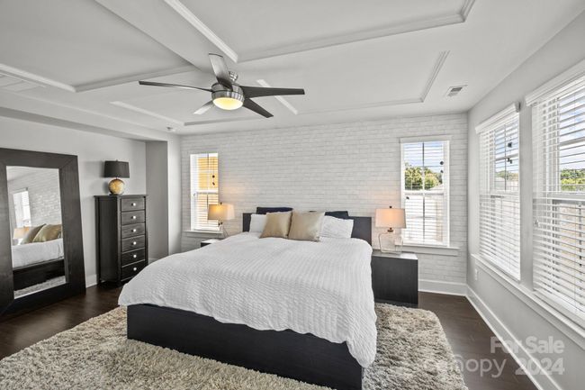 Upper level features primary bedroom suite with feature wall. | Image 17