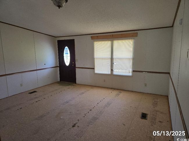 Entryway featuring a textured ceiling and a decorative wall | Image 17