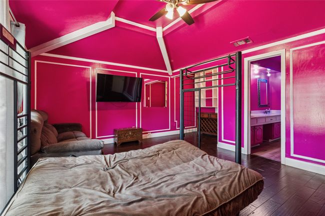 Bedroom featuring vaulted ceiling, hardwood / wood-style floors, and connected bathroom | Image 18
