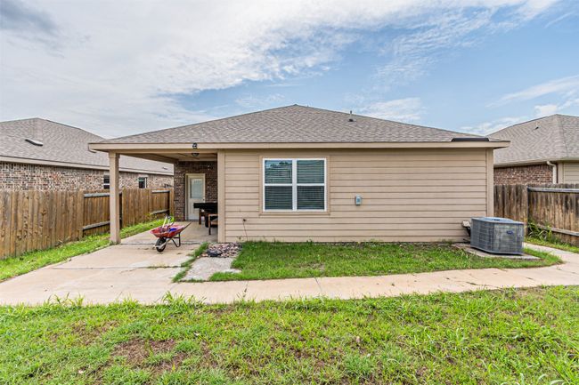 Rear view of house featuring cooling unit and a patio area | Image 32