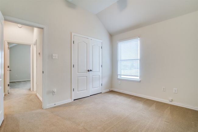 Another view of 1st guest bedroom featuring carpet and lofted ceiling | Image 19