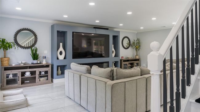 Living area with recessed lighting, crown molding, stairway, and light marble finish floors | Image 9