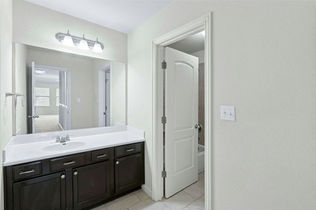 Full bathroom with vanity, tile patterned flooring, and shower combination | Image 30