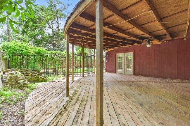 Enjoy the privacy of a fully fenced backyard, shaded by mature trees. | Image 27