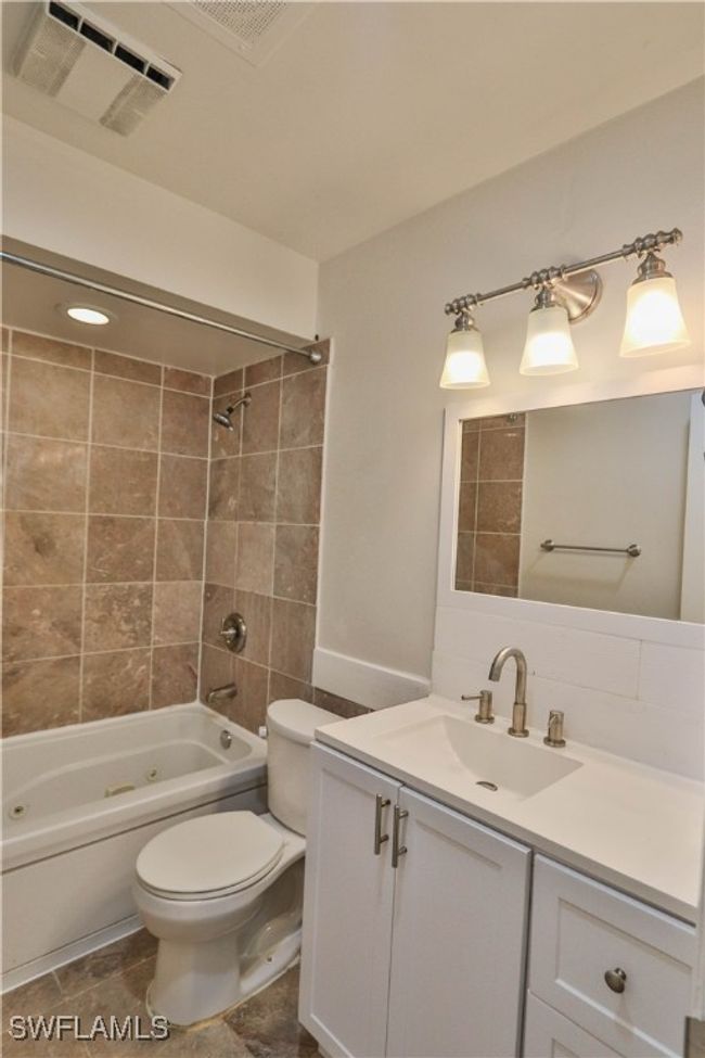 Full bathroom with toilet, vanity, and shower / washtub combination | Image 28