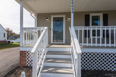 Entrance to property featuring central AC unit and a porch | Image 2