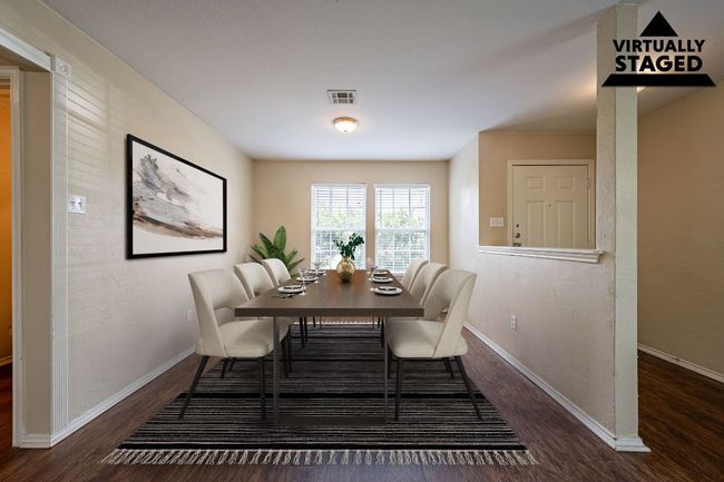 Dining space with wood finished floors and baseboards | Image 7