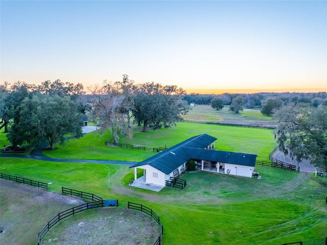 A concrete block T-shaped shed-row barn features six stalls, a spacious sand-covered run-in, and a small fully equiped apartment-ideal for a farm hand or a guest retreat and refreshment area. | Image 53