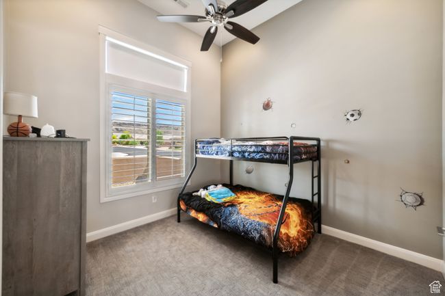 Carpeted bedroom with a ceiling fan and baseboards | Image 23