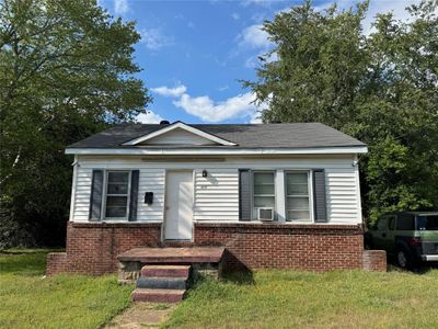 View of front of home with cooling unit and a front yard | Image 1