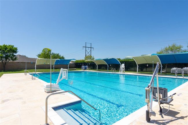 Pool with a patio area and fence | Image 25