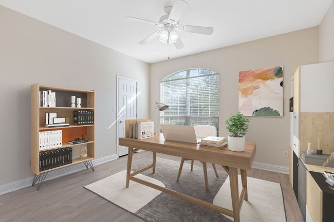 Home office featuring baseboards, light wood-style flooring, and a ceiling fan | Image 4