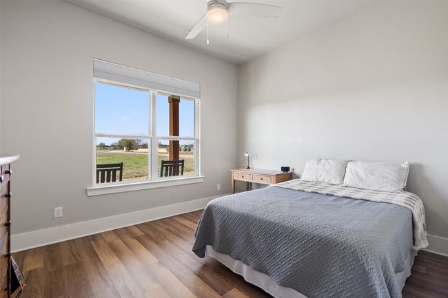 Bedroom featuring baseboards, wood finished floors, and a ceiling fan | Image 18