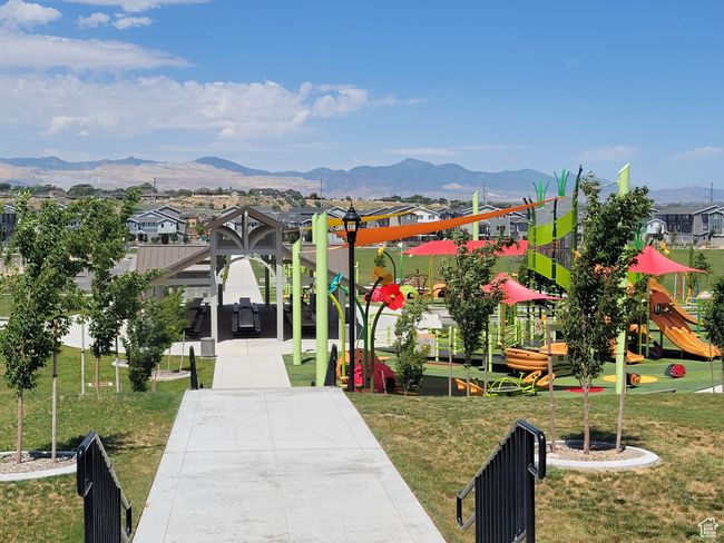 View of community featuring a playground, a lawn, and a mountain view | Image 5