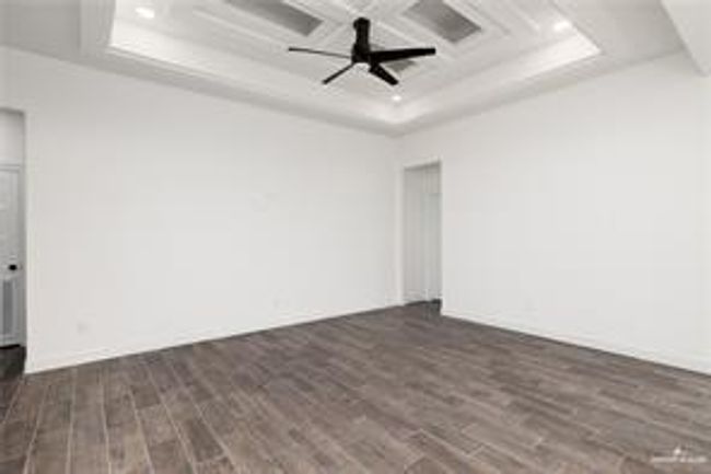 Unfurnished room with recessed lighting, coffered ceiling, a raised ceiling, wood finished floors, and a ceiling fan | Image 5