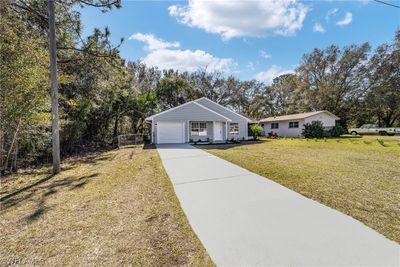 Ranch-style home with a front lawn and a garage | Image 2