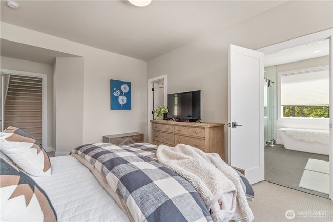 The spacious primary bedroom offers peaceful privacy, thoughtfully separated from the other bedrooms | Image 18