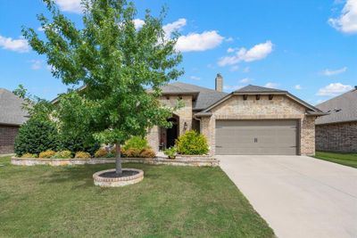 View of front facade with a front yard and a garage | Image 1