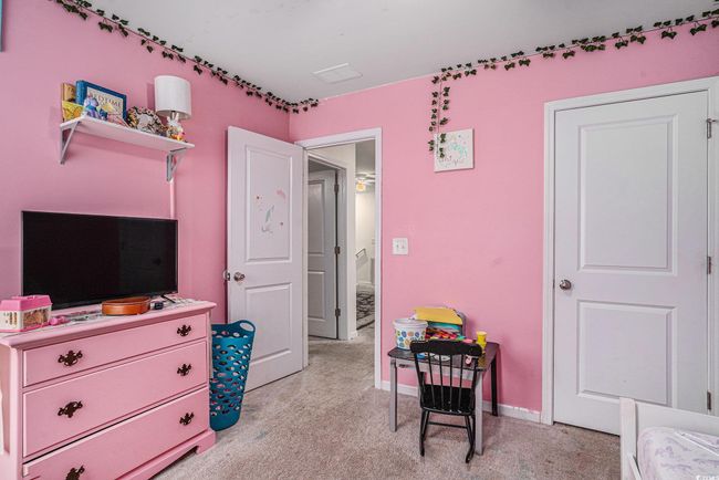 Bedroom with light colored carpet and baseboards | Image 16