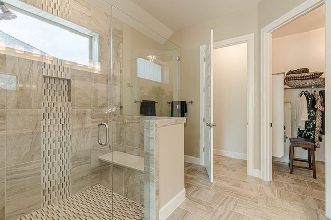 Bathroom featuring a shower stall and baseboards | Image 30