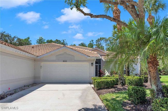 Ranch-style house with driveway, an attached garage, a tile roof, and stucco siding | Image 28