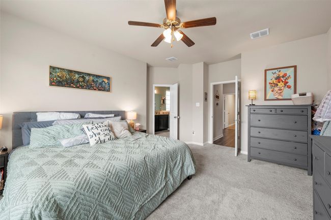 Bedroom featuring light carpet, a ceiling fan, and ensuite bathroom | Image 16