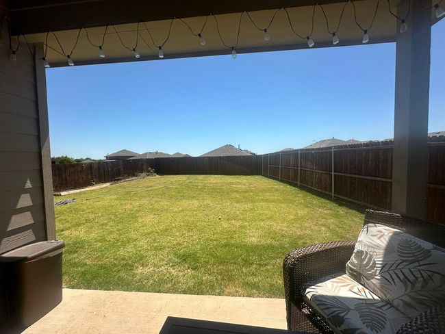 View of fenced backyard | Image 15