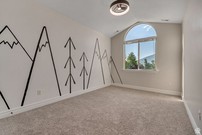 Carpeted spare room featuring vaulted ceiling and baseboards | Image 20