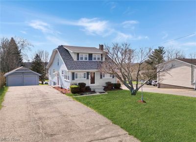 View of front of home with a front lawn and a garage | Image 1