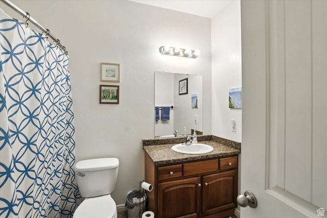 Bathroom with vanity and curtained shower | Image 17