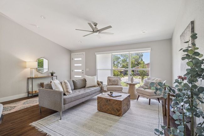 Living room with wood finished floors, ceiling fan, and recessed lighting | Image 8