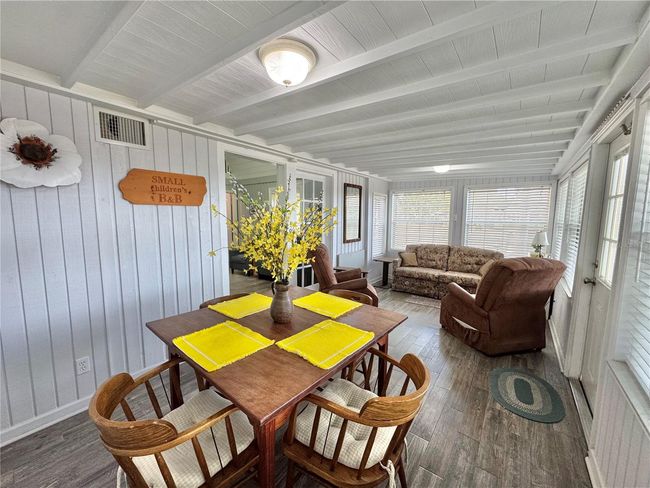 Front Florida room with a pull out couch for sleeping and chairs for sitting area and table/chairs eating area. Can be closed off for privacy. | Image 22
