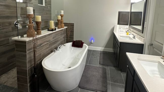Bathroom with two vanities, a walk in shower, a soaking tub, and tile patterned floors | Image 9