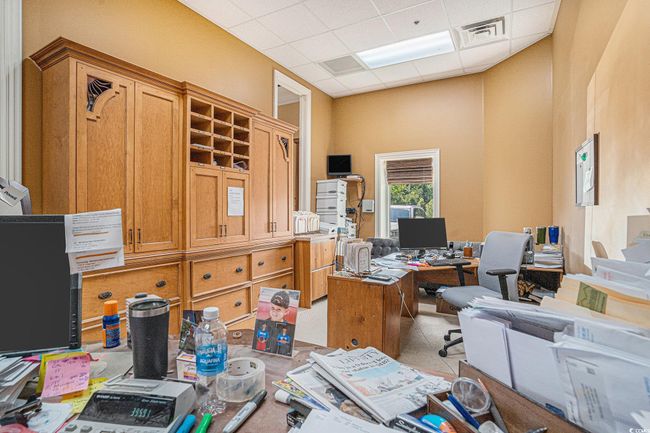 Home office featuring a drop ceiling | Image 11