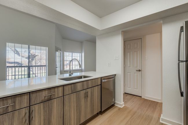 Kitchen with sink, light wood-type flooring, and appliances with stainless steel finishes | Image 17