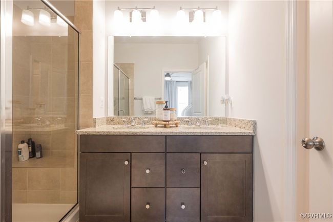 Full bath featuring a sink, double vanity, and a stall shower | Image 33
