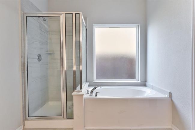 The soaking tub and separate shower offer additional space and a relaxing retreat. | Image 18