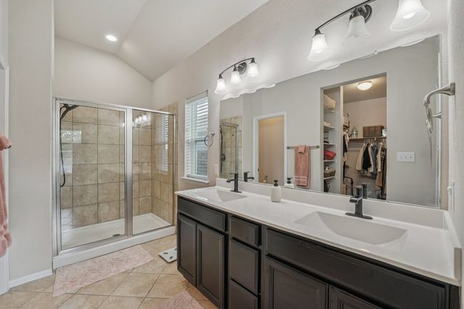 Spa like primary bathroom with dual vanity sinks and walk in shower. Love the window for great natural light | Image 14